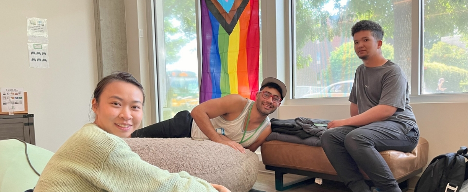 three students relaxing and smiling